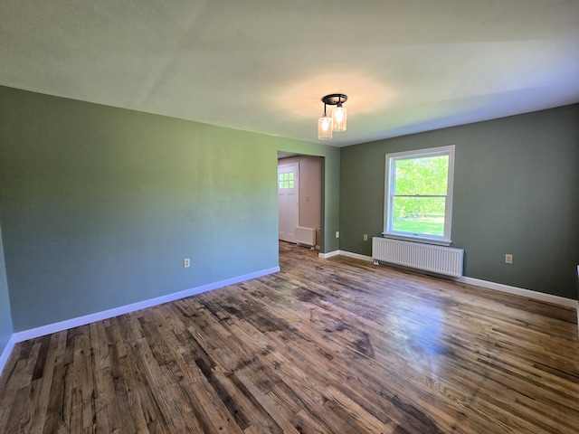 237 Bangor Rd, Unity, ME 04988 - empty room featuring radiator, baseboards, and dark wood-style flooring