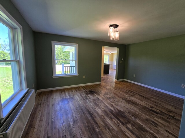 237 Bangor Rd, Unity, ME 04988 - spare room with radiator, healthy amount of natural light, dark wood-style floors, and baseboards