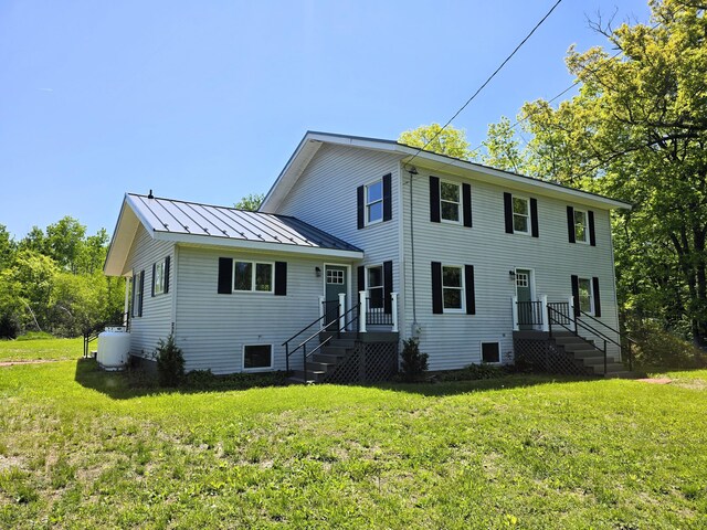 237 Bangor Rd, Unity, ME 04988 - rear view of property with a standing seam roof, a yard, and metal roof