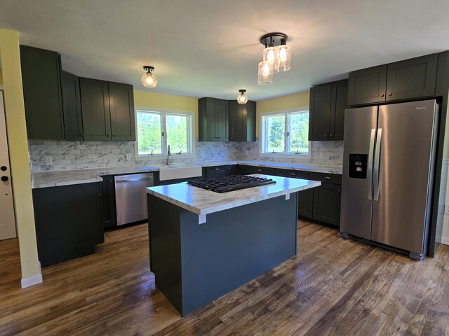 237 Bangor Rd, Unity, ME 04988 - kitchen featuring appliances with stainless steel finishes, backsplash, a sink, light countertops, and dark wood-type flooring