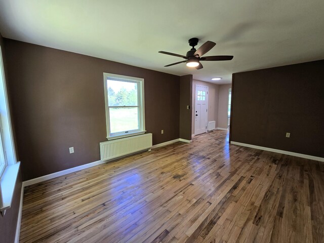 237 Bangor Rd, Unity, ME 04988 - spare room with radiator heating unit, wood finished floors, baseboards, and a ceiling fan