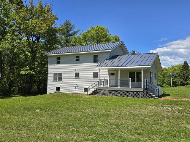 237 Bangor Rd, Unity, ME 04988 - back of property featuring a porch, a lawn, a standing seam roof, and metal roof