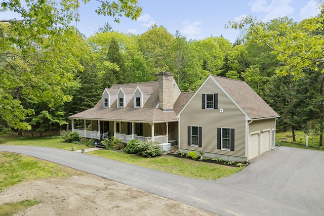 10 Ledge Hill Rd, Gorham, ME 04038 - view of front of house with a chimney, a porch, driveway, a garage, and a front yard