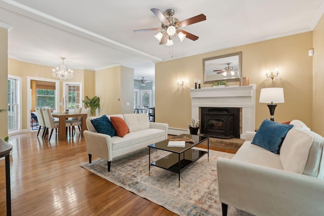 10 Ledge Hill Rd, Gorham, ME 04038 - living area featuring a ceiling fan, hardwood / wood-style flooring, a wood stove, healthy amount of natural light, and crown molding