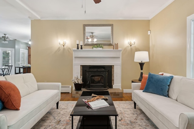 10 Ledge Hill Rd, Gorham, ME 04038 - living area with a ceiling fan, baseboard heating, a wood stove, wood finished floors, and ornamental molding