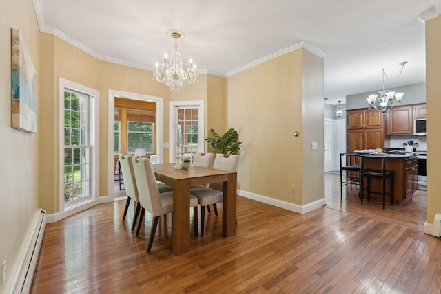 10 Ledge Hill Rd, Gorham, ME 04038 - dining area featuring a chandelier, a baseboard heating unit, light wood-style flooring, baseboards, and ornamental molding