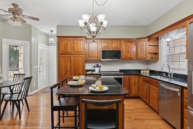 10 Ledge Hill Rd, Gorham, ME 04038 - kitchen featuring appliances with stainless steel finishes, a sink, brown cabinets, light wood-style flooring, and plenty of natural light