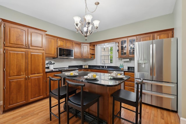 10 Ledge Hill Rd, Gorham, ME 04038 - kitchen featuring stainless steel appliances, dark countertops, tasteful backsplash, a sink, and brown cabinetry
