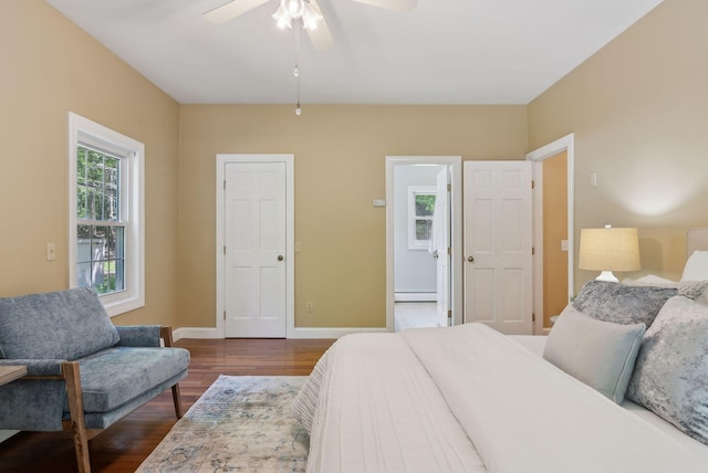 10 Ledge Hill Rd, Gorham, ME 04038 - bedroom featuring a baseboard radiator, dark wood-style floors, baseboards, and a ceiling fan