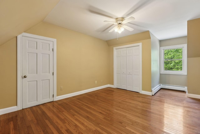 10 Ledge Hill Rd, Gorham, ME 04038 - unfurnished bedroom featuring a baseboard heating unit, wood finished floors, vaulted ceiling, baseboards, and a ceiling fan