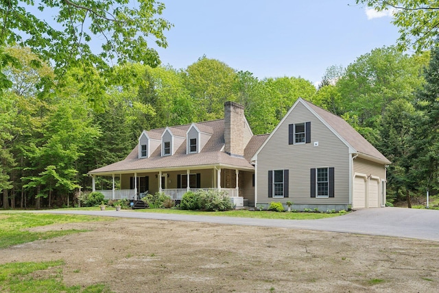 10 Ledge Hill Rd, Gorham, ME 04038 - view of front facade with covered porch, a chimney, asphalt driveway, and central AC
