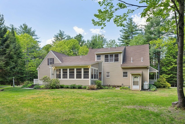 10 Ledge Hill Rd, Gorham, ME 04038 - rear view of house featuring a sunroom, a yard, a chimney, and roof with shingles