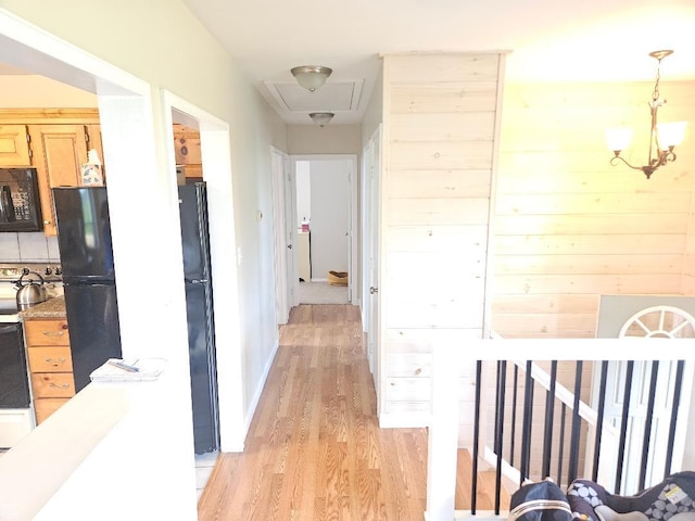 262 Golf Course Rd, Newport, ME 04953 - hall featuring light wood-style flooring, attic access, and a chandelier