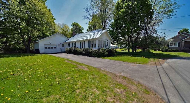 6 Pleasant Ct, Houlton, ME 04730 - single story home with a front lawn, driveway, metal roof, and a chimney