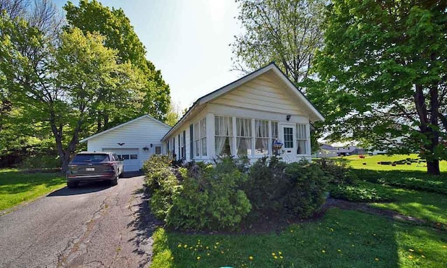 6 Pleasant Ct, Houlton, ME 04730 - view of front facade with a garage, an outbuilding, a front yard, and asphalt driveway
