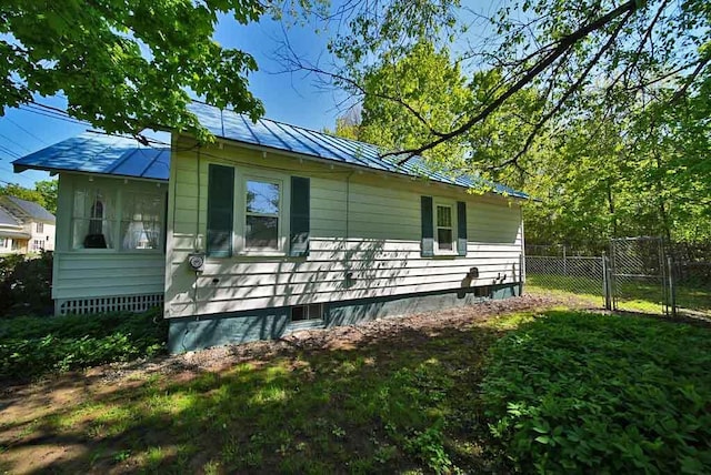 6 Pleasant Ct, Houlton, ME 04730 - view of side of property with a standing seam roof, metal roof, and a gate