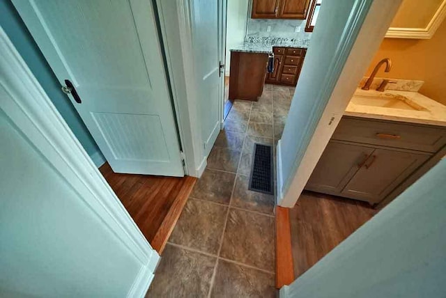6 Pleasant Ct, Houlton, ME 04730 - bathroom with vanity, tile patterned flooring, and backsplash