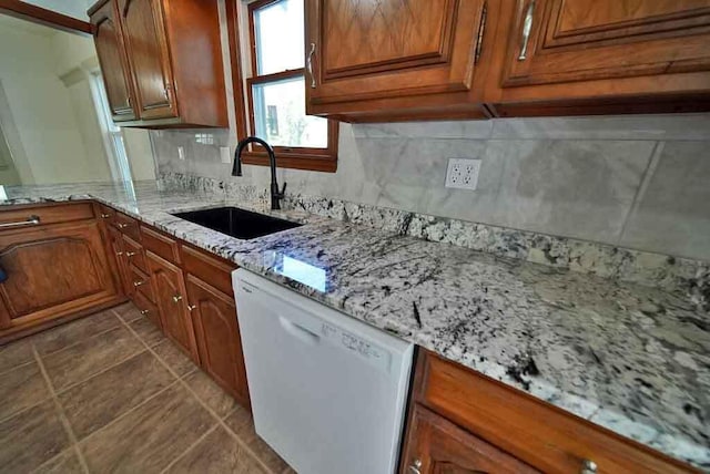 6 Pleasant Ct, Houlton, ME 04730 - kitchen with white dishwasher, a sink, brown cabinets, and tile patterned flooring