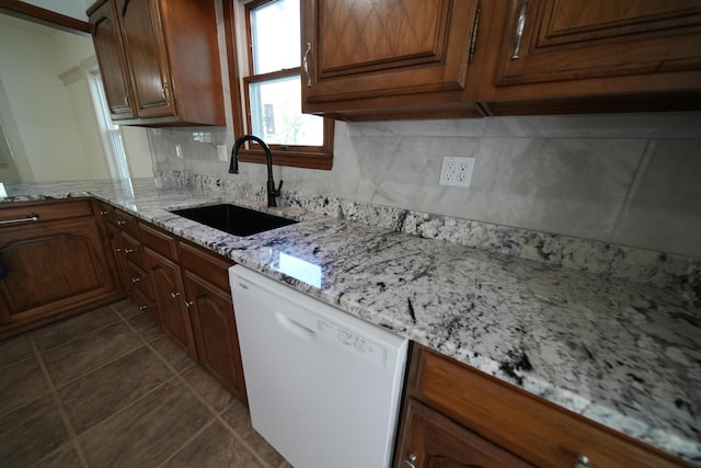6 Pleasant Ct, Houlton, ME 04730 - kitchen featuring white dishwasher, a sink, tasteful backsplash, dark tile patterned flooring, and light stone counters