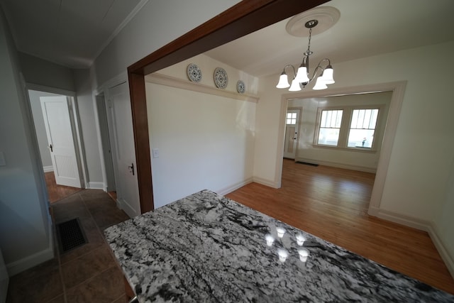 6 Pleasant Ct, Houlton, ME 04730 - unfurnished dining area featuring a chandelier, baseboards, and wood finished floors