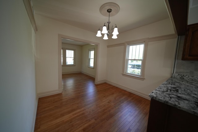 6 Pleasant Ct, Houlton, ME 04730 - unfurnished dining area with wood finished floors, a chandelier, and baseboards