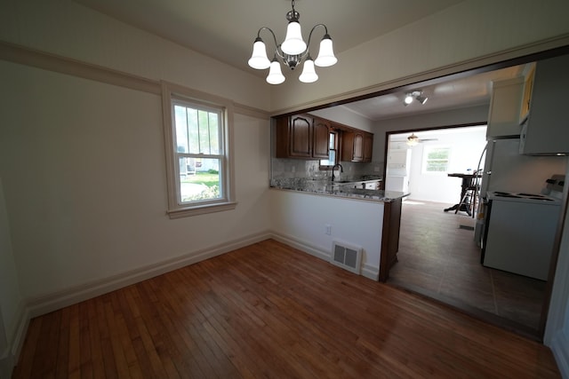 6 Pleasant Ct, Houlton, ME 04730 - kitchen featuring electric stove, a sink, dark wood finished floors, a chandelier, and backsplash