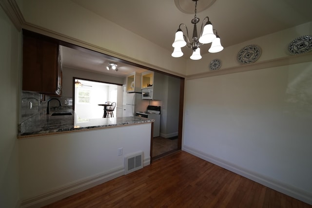 6 Pleasant Ct, Houlton, ME 04730 - kitchen with a sink, a chandelier, dark wood finished floors, stone counters, and white appliances