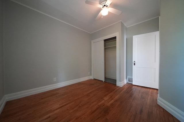 6 Pleasant Ct, Houlton, ME 04730 - unfurnished bedroom with crown molding, dark wood-style floors, baseboards, a closet, and ceiling fan
