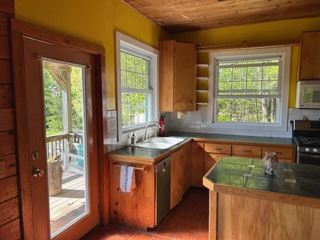20 Monument Rd, Abbot, ME 04406 - kitchen featuring stainless steel appliances, a sink, wooden ceiling, decorative backsplash, and brown cabinets