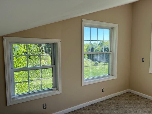 20 Monument Rd, Abbot, ME 04406 - spare room with lofted ceiling, plenty of natural light, baseboards, and carpet floors