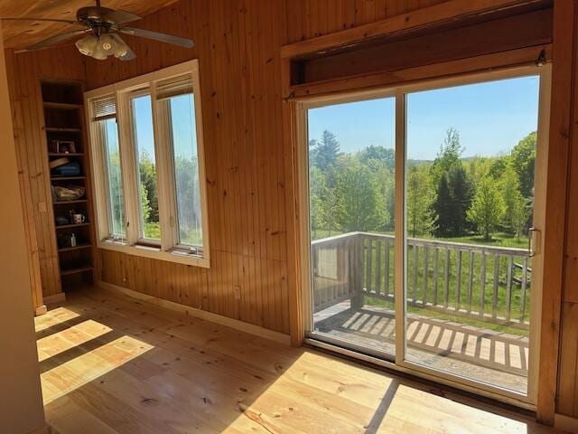 20 Monument Rd, Abbot, ME 04406 - doorway to outside with wooden walls, hardwood / wood-style flooring, plenty of natural light, and ceiling fan