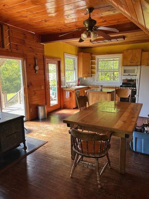 20 Monument Rd, Abbot, ME 04406 - dining room with a wood stove, wood ceiling, hardwood / wood-style floors, plenty of natural light, and a ceiling fan