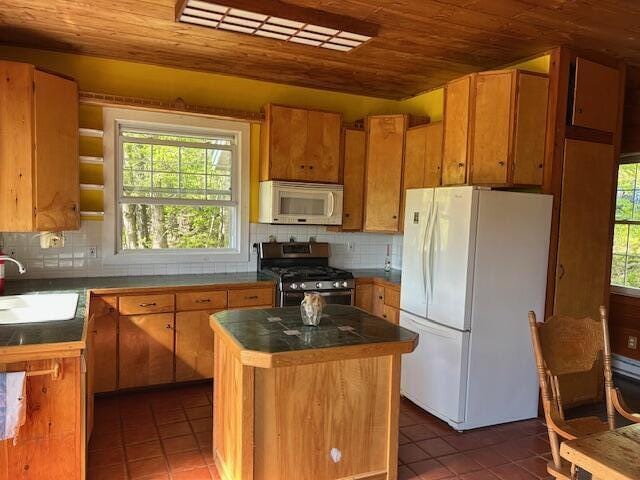 20 Monument Rd, Abbot, ME 04406 - kitchen with white appliances, a sink, tile patterned floors, wood ceiling, and dark countertops