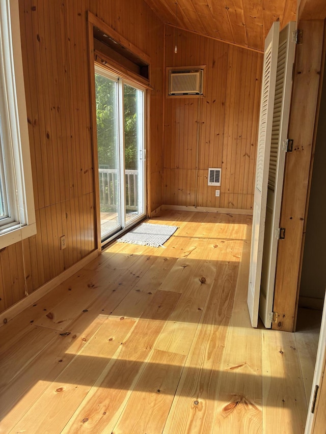 20 Monument Rd, Abbot, ME 04406 - unfurnished room with wooden walls, vaulted ceiling, and hardwood / wood-style floors