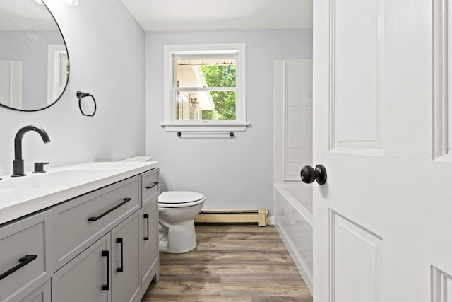 30 Ring Landing Rd, Casco, ME 04015 - bathroom featuring a baseboard radiator, vanity, toilet, and wood finished floors