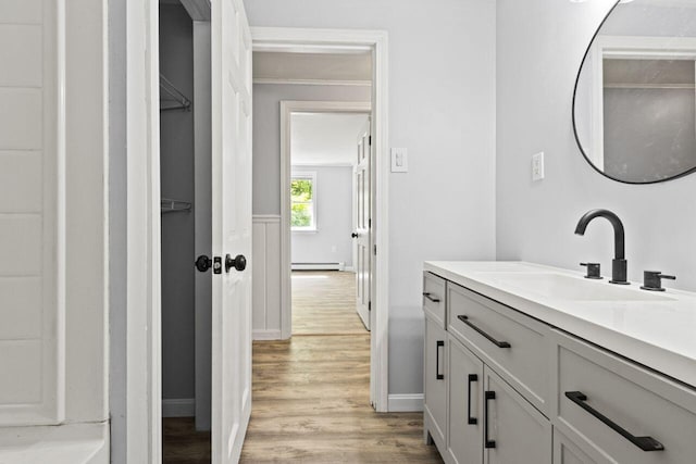 30 Ring Landing Rd, Casco, ME 04015 - bathroom featuring a baseboard heating unit, vanity, wood finished floors, and baseboards