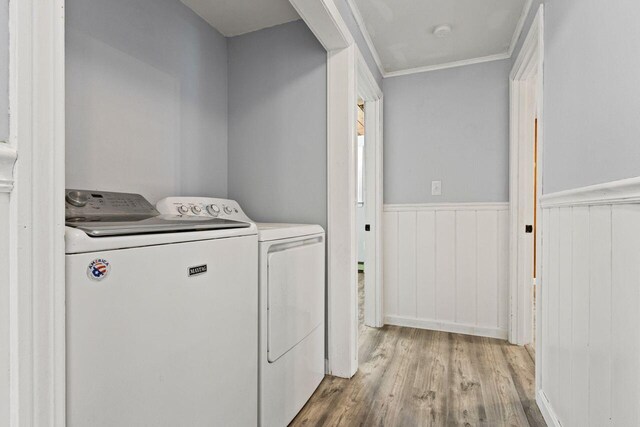 30 Ring Landing Rd, Casco, ME 04015 - laundry room with washer and clothes dryer, wood finished floors, and ornamental molding
