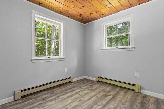 30 Ring Landing Rd, Casco, ME 04015 - unfurnished room with a baseboard radiator, wood finished floors, baseboards, and wood ceiling