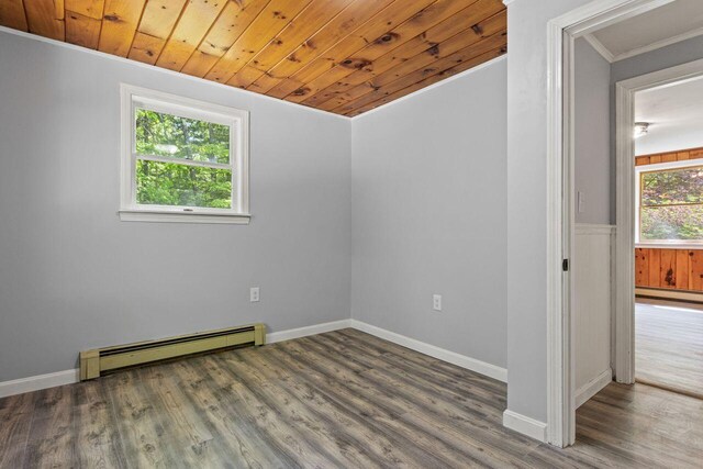 30 Ring Landing Rd, Casco, ME 04015 - empty room featuring a baseboard heating unit, crown molding, wood finished floors, baseboards, and wood ceiling