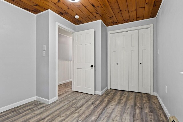 30 Ring Landing Rd, Casco, ME 04015 - unfurnished bedroom with wooden ceiling, wood finished floors, a closet, baseboards, and ornamental molding