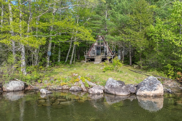 74 Snow Village Rd, Liberty, ME 04949 - back of property featuring a wooden deck, stairway, and a view of trees