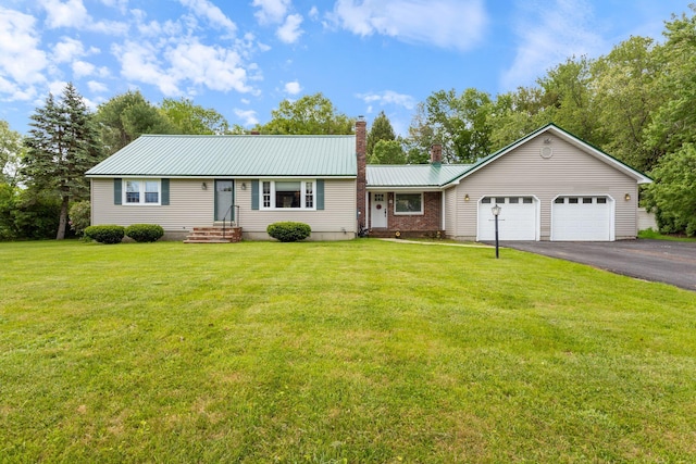 18 Tibbetts Ln, Lyman, ME 04002 - ranch-style house with a chimney, driveway, an attached garage, metal roof, and a front yard