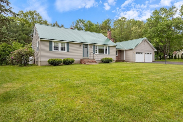 18 Tibbetts Ln, Lyman, ME 04002 - view of front of property with asphalt driveway, metal roof, a chimney, a front yard, and a garage