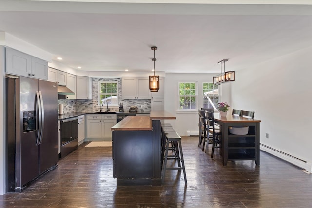 18 Tibbetts Ln, Lyman, ME 04002 - kitchen featuring appliances with stainless steel finishes, wooden counters, a baseboard radiator, a sink, and dark wood finished floors