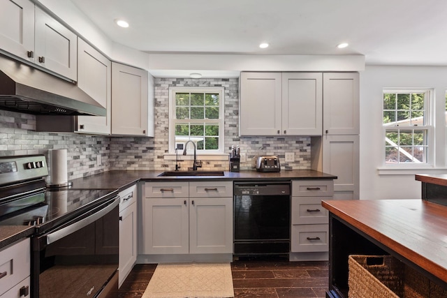 18 Tibbetts Ln, Lyman, ME 04002 - kitchen with electric stove, black dishwasher, a sink, under cabinet range hood, and decorative backsplash