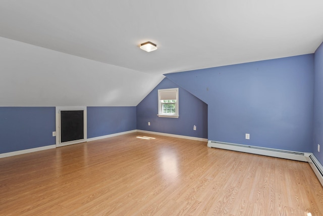 18 Tibbetts Ln, Lyman, ME 04002 - bonus room with light wood finished floors, vaulted ceiling, a baseboard heating unit, and baseboards