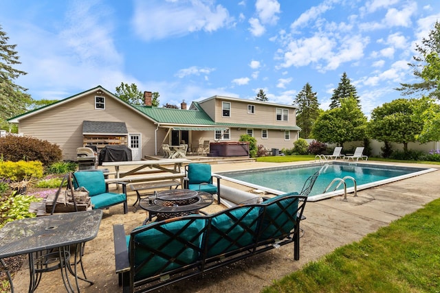 18 Tibbetts Ln, Lyman, ME 04002 - view of swimming pool featuring an outdoor fire pit, a patio, and a hot tub