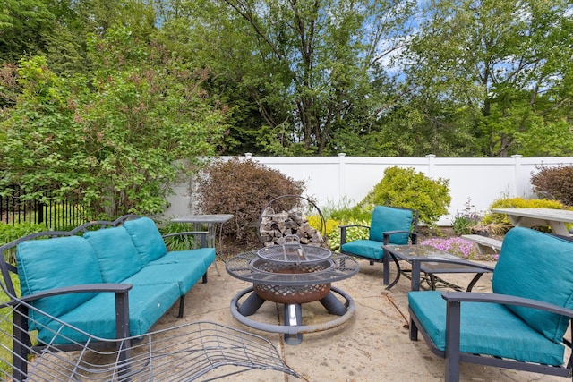 18 Tibbetts Ln, Lyman, ME 04002 - fenced backyard featuring a patio area and an outdoor living space with a fire pit