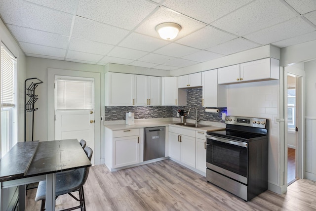 1 Fair St, Lewiston, ME 04240 - kitchen featuring stainless steel appliances, a sink, a drop ceiling, light wood-type flooring, and white cabinetry