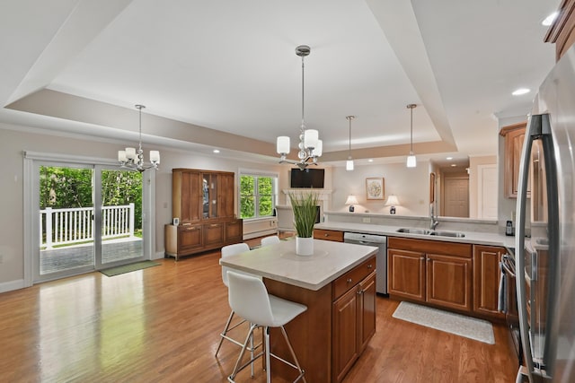 40 Camden Ct Unit 40, Bangor, ME 04401 - kitchen featuring a tray ceiling, a chandelier, appliances with stainless steel finishes, brown cabinetry, and recessed lighting